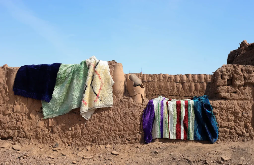 A display of moroccan silk rugs