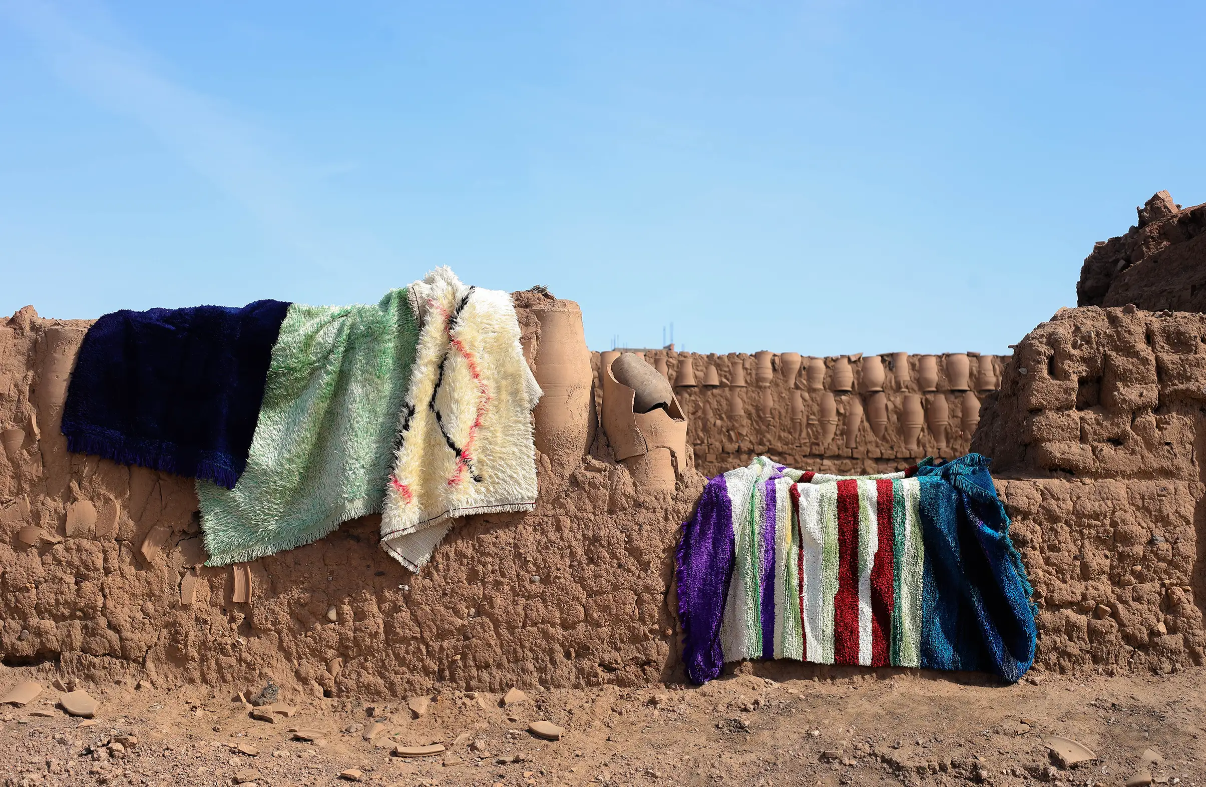 A display of moroccan silk rugs